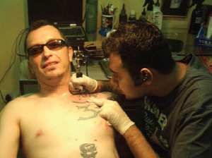 Giving his 85th tatoo