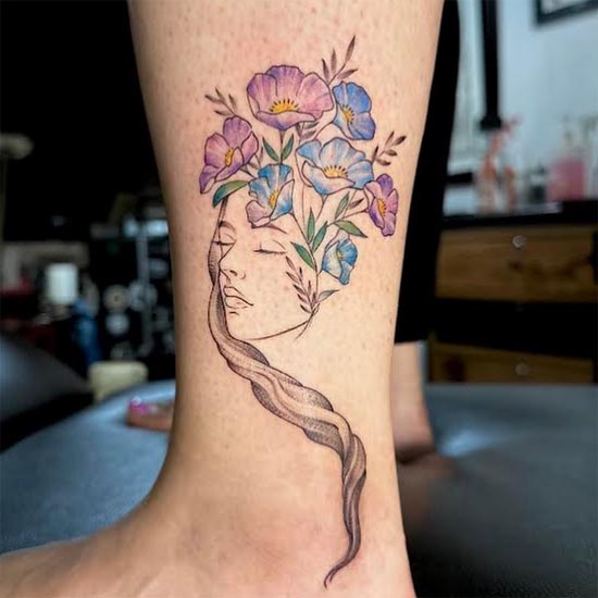 female face with flowers tattoo color girl ankle