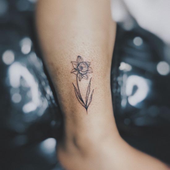 floral tattoo design idea woman outer ankle