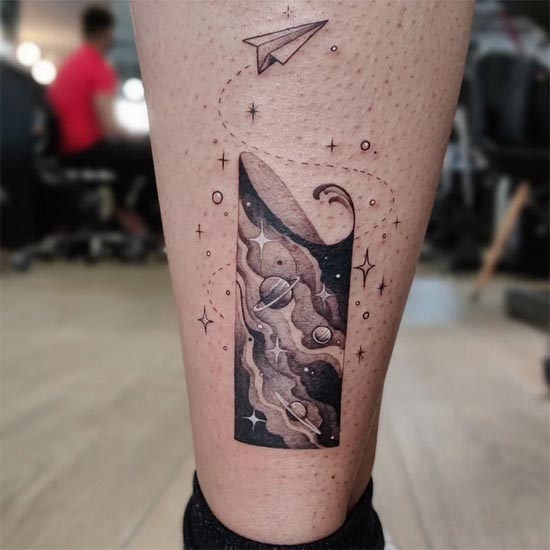 galaxy panel paper airplane tattoo design female back ankle