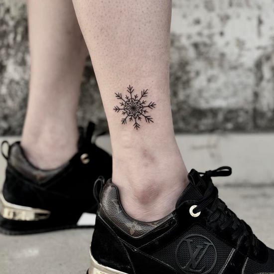 snowflake tattoo design woman outer ankle