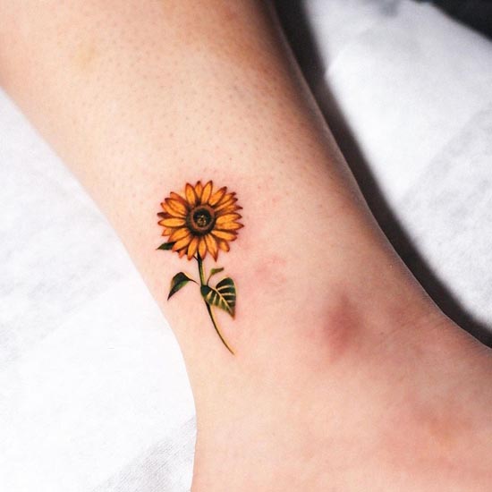 sunflower with leaves tattoo design yellow female inner ankle