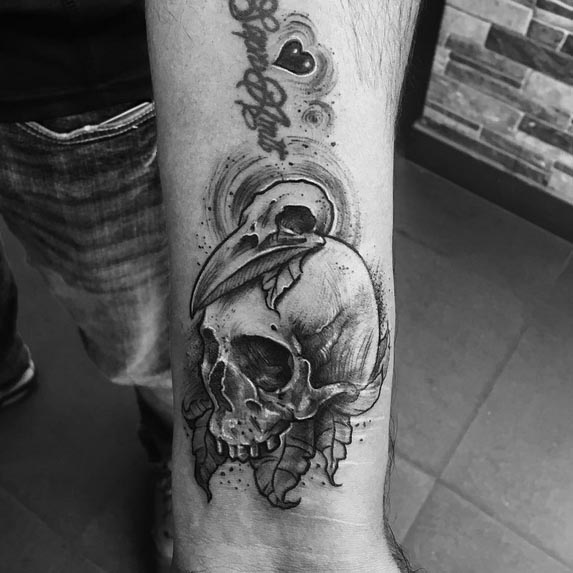 human skull bird skull tattoo man arm front forearm