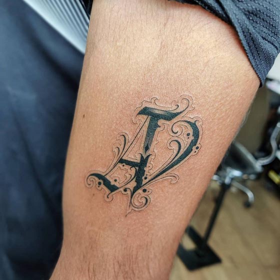 name initial a tattoo design guy upper arm outer bicep