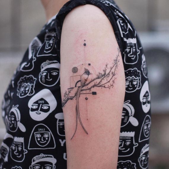 paradise flycatcher bird tattoo geometric fine line girl arm bicep