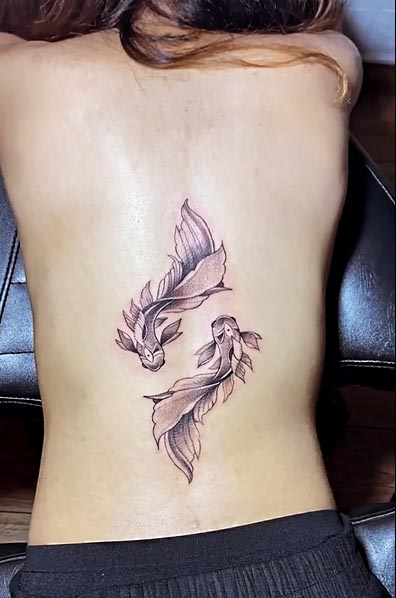 koi fish tattoo fineline female lower back