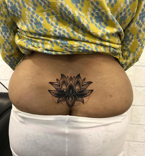 lotus tattoo woman lower back