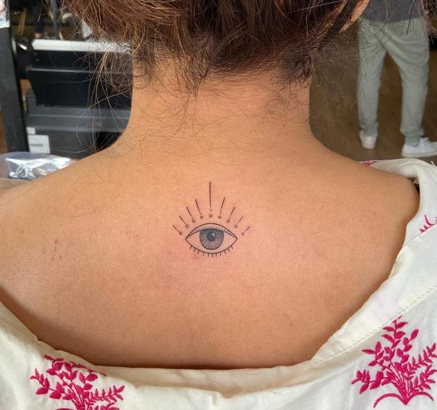 small simple eye tattoo fineline minimalist female back