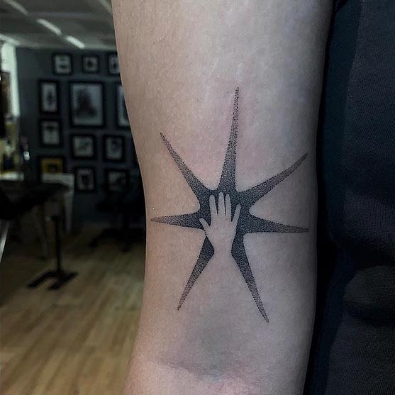 6 point star with hand tattoo designs woman front bicep