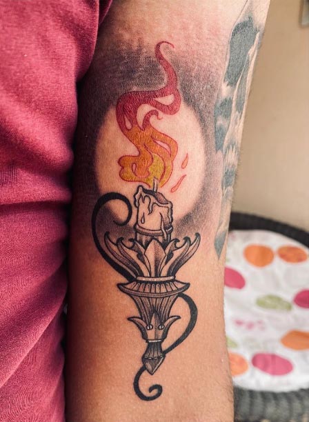 gothic candle burning tattoo guy front bicep