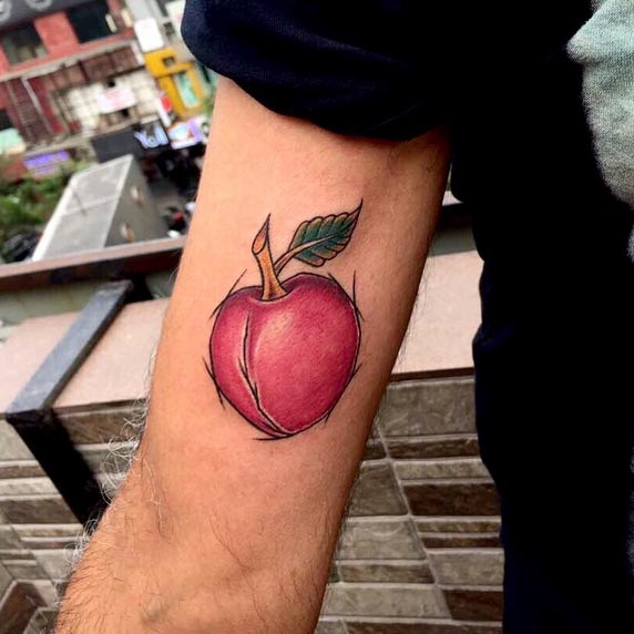 small apple tattoo color red male inner bicep