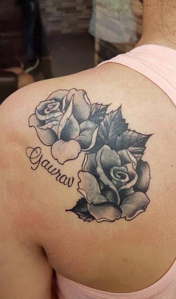 female shoulder back loved one name with rose