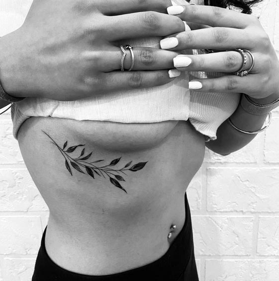 floral leaves simple tattoo minimalist woman under right breast