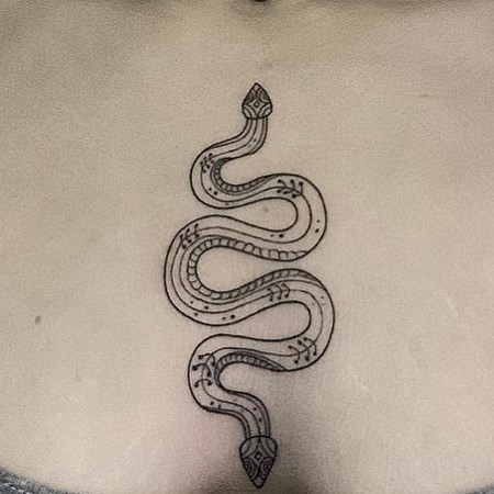 small snake tattoo design woman between breast