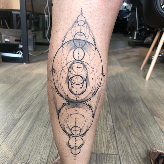 geometric circles tattoo design man back calf