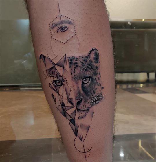 half geometric half realistic leopard with human eye tattoo male calf