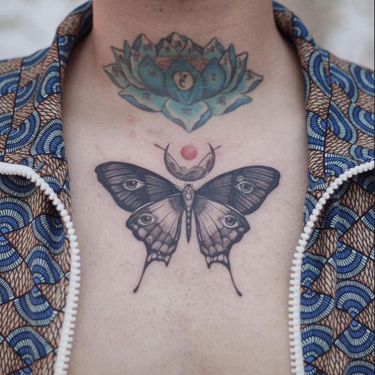 butterfly eyes on wings and crescent moon tattoo design man upper chest