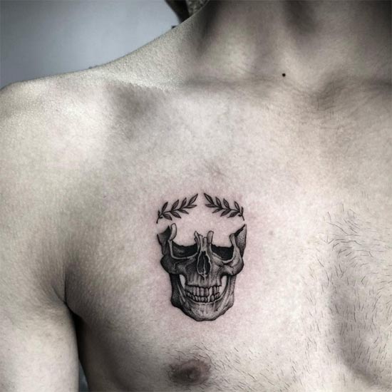 leaves on top of skull small tattoo design man chest