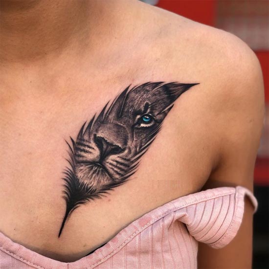 lion face in feather tattoo design woman chest