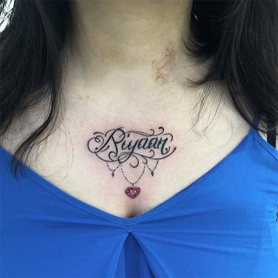 name riyaan calligraphy with ornament tattoo design woman upper chest