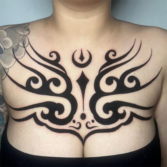 traditional tribal tattoo blackout female full chest