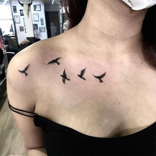 5 flying birds tattoo female outer upper collarbone