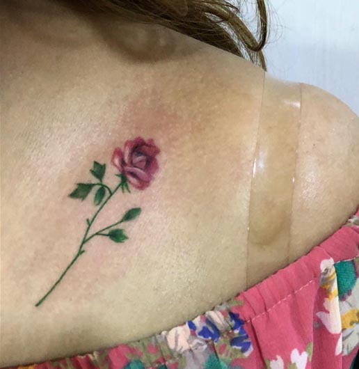 minimalist rose tattoo color design woman collarbone