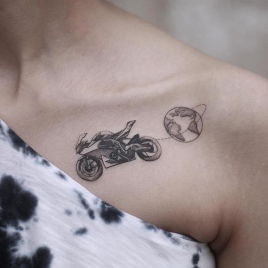 travel bike world map tattoo small lady under collarbone