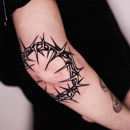 crown of thorns round tattoo design woman around elbow