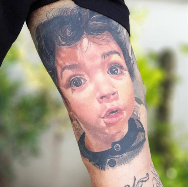 son portrait on arm father