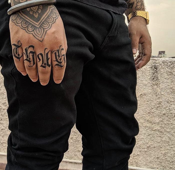 4 letter word thug tattoo design male finger