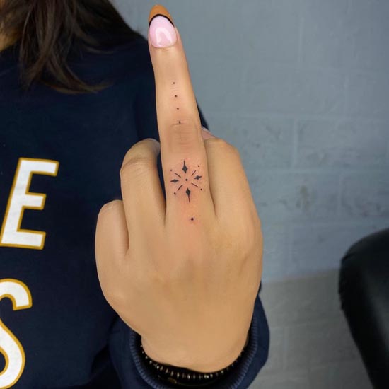 cute minimal ornamental tattoo female middle finger