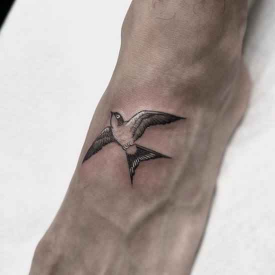 swallow bird minimalist tattoo design female upper foot