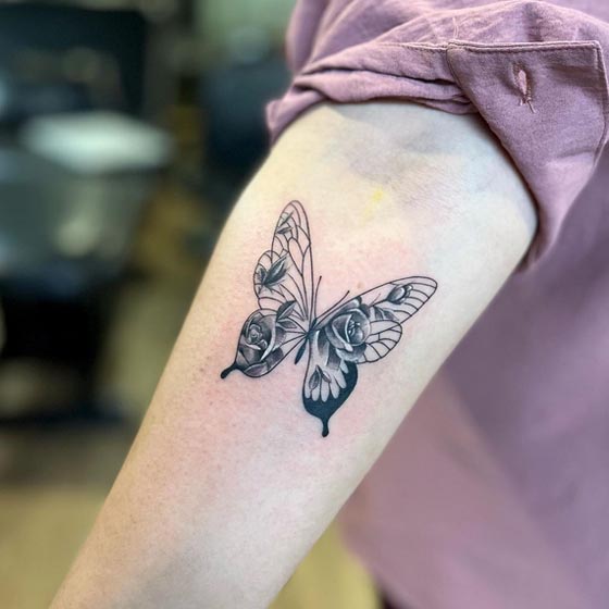 butterfly roses on wings tattoo black and grey girl inner forearm