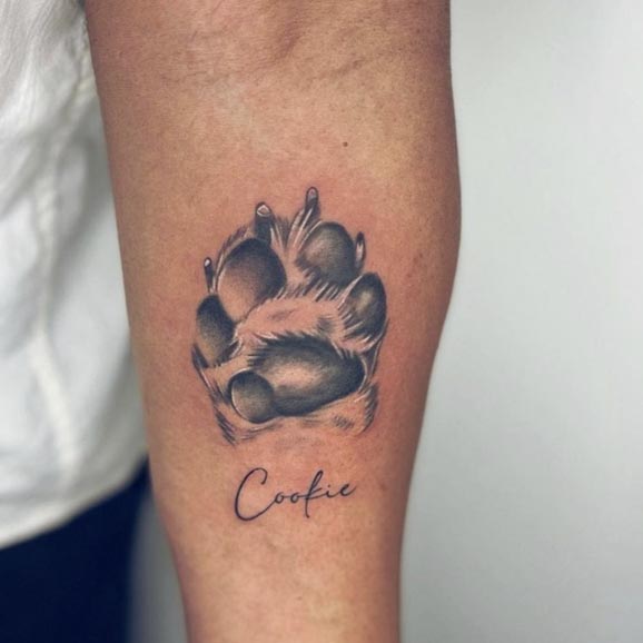 dog paw with lettering cookie cute tattoo male inner forearm