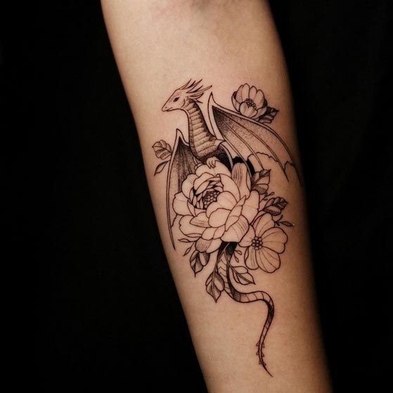 dragon with delicate peony flowers tattoo female forearm