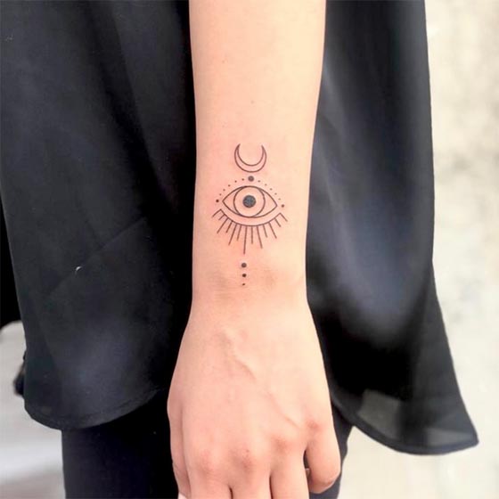 evil eye small easy tattoo design linework woman outer lower forearm