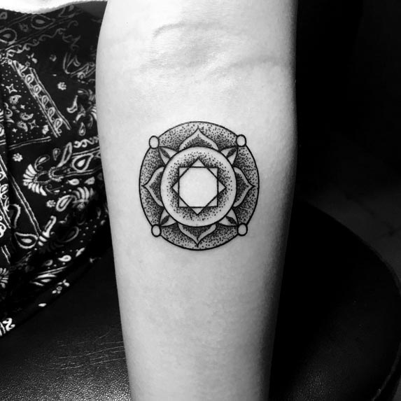 mandala circle dotwork small tattoo woman upper forearm