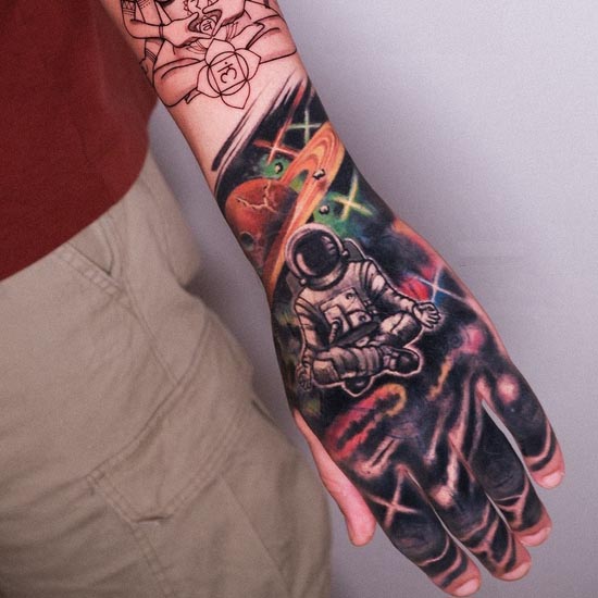 astronaut galaxy space tattoo design male hand wrist