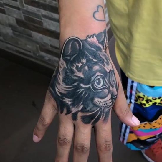 cat tattoo design on boy hand black and grey