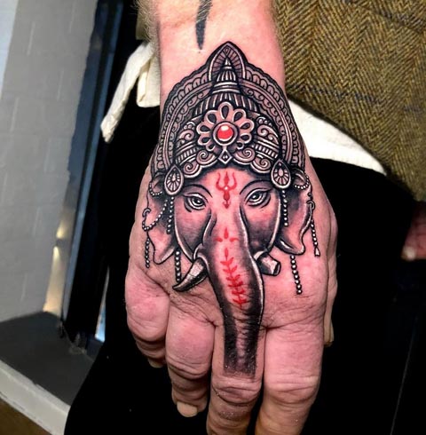 ganesha face unique tattoo design male hand