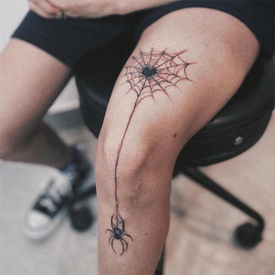 spider hanging from spiderweb cool tattoo guy above knee to below knee