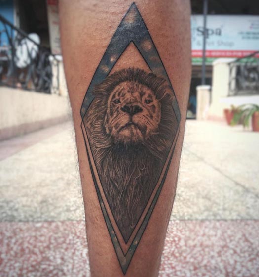 lion face in rhombus shape tattoo design boy leg calf