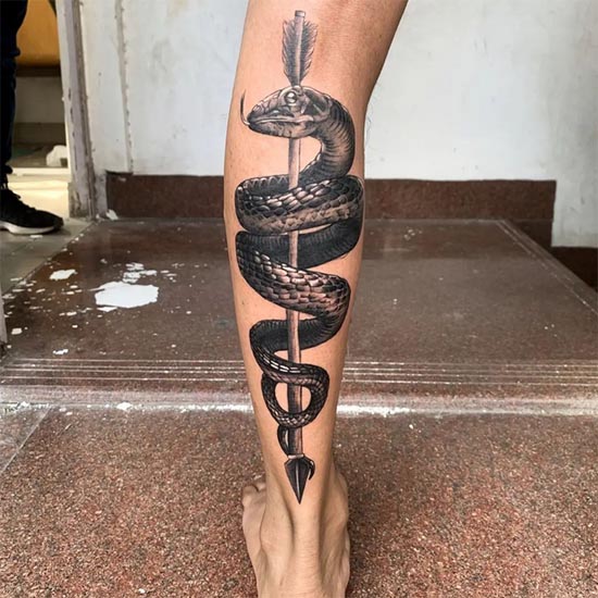 snake wrapped around arrow tattoo design hyperrealism boy back leg