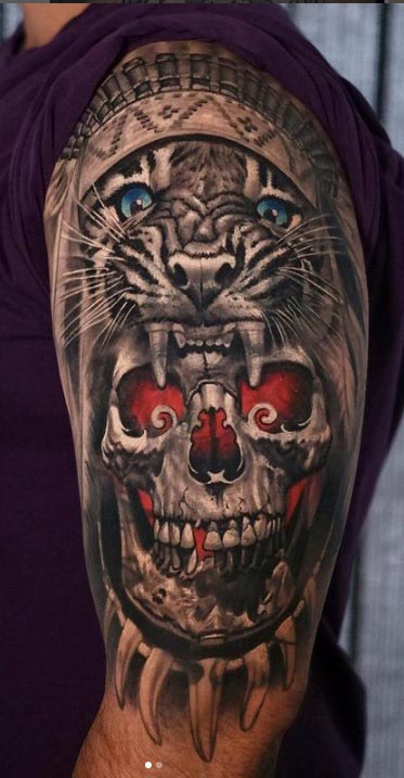 upper arm lion and skull tattoo