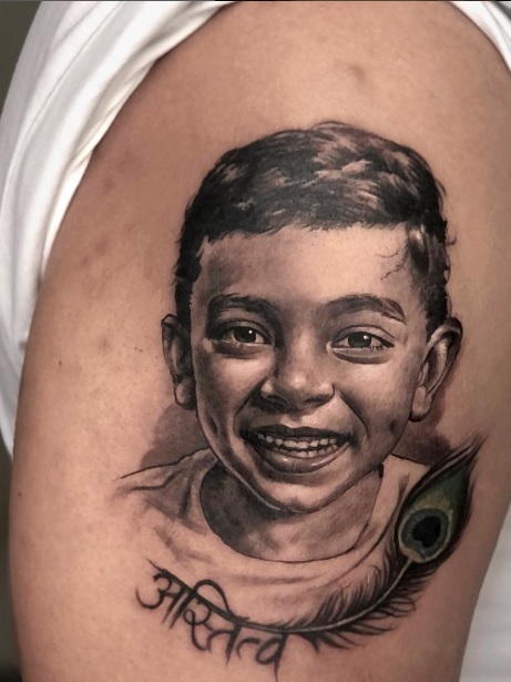 upper arm portrait tattoo