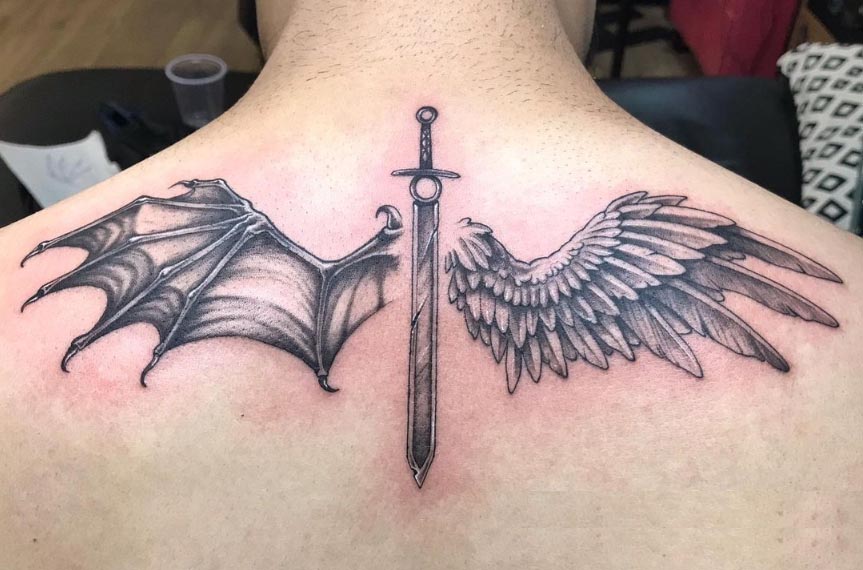 half angel half devil wings sword in center tattoo man nape