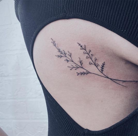 cute small flowers with leaves tattoo female ribcage under breast