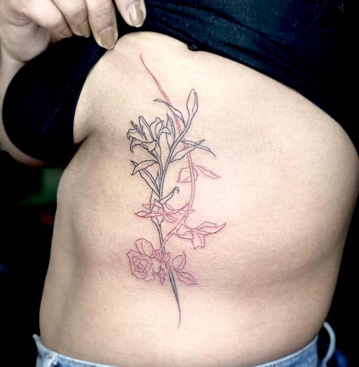 floral tattoo design fine line woman vertical ribcage red and black