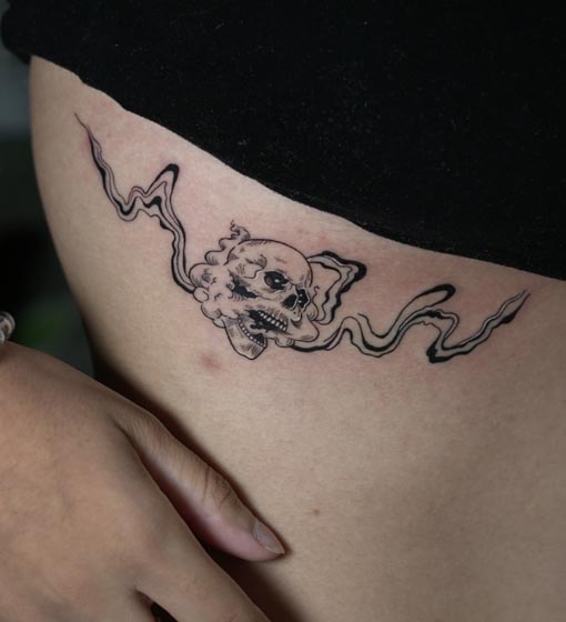 skull unique tattoo on female front rib